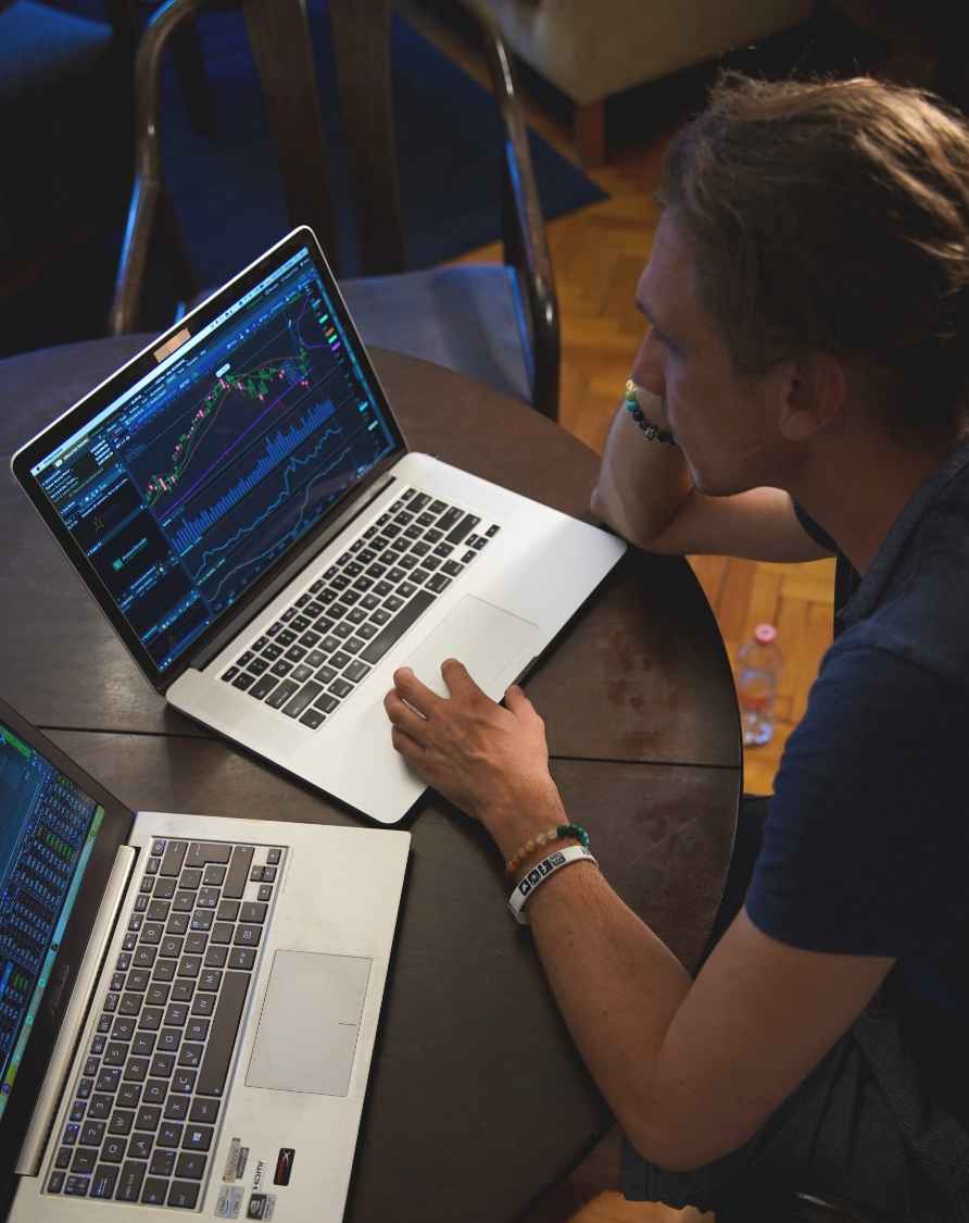 Image of a man working on a laptop and monitoring his work remotely through virtualization.